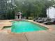 Inviting in-ground pool with surrounding lounge chairs, ready for summer relaxation at 284 Harris Loop, Dallas, GA 30157