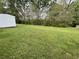 Lush backyard with plentiful green space and mature trees at 66 Lakeshore Dr, Bowdon, GA 30108