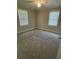 Relaxing bedroom featuring neutral walls, soft carpeting, and natural light from the two bright windows at 66 Lakeshore Dr, Bowdon, GA 30108
