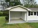 Covered carport featuring a concrete floor and a door to the house at 66 Lakeshore Dr, Bowdon, GA 30108