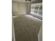 Bright living room with neutral walls, new carpet, and large windows for natural light at 66 Lakeshore Dr, Bowdon, GA 30108