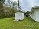 Backyard storage shed with ramp access, ideal for storing equipment at 66 Lakeshore Dr, Bowdon, GA 30108