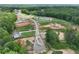 Overhead shot of a new neighborhood and community with beautiful wooded surrounding areas and gray asphalt roadways at 133 Prescott Manor Dr, Canton, GA 30115