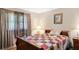 Cozy bedroom featuring a colorful quilt, wood furniture, and natural light from the window at 2365 Fontaine Cir, Decatur, GA 30032