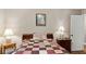 Comfortable bedroom with a wooden bed frame, quilt, bedside tables, and soft lighting at 2365 Fontaine Cir, Decatur, GA 30032