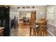 Open dining area with a stainless steel refrigerator in the foreground and multiple dining tables at 2365 Fontaine Cir, Decatur, GA 30032