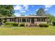 Charming brick home with well-kept lawn, trimmed bushes, and a covered car port at 2365 Fontaine Cir, Decatur, GA 30032