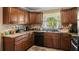 Traditional kitchen featuring wood cabinets, tile backsplash, and granite countertops at 2365 Fontaine Cir, Decatur, GA 30032