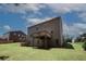Large, grassy backyard with a deck, offering plenty of space for outdoor activities at 2405 Brisbane Dr, Conyers, GA 30013