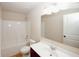 Bright bathroom with a shower-tub combination, white tile surround, and ample vanity storage space at 2405 Brisbane Dr, Conyers, GA 30013
