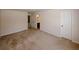 Spacious bedroom featuring plush carpeting, neutral walls, and a private door to an en-suite bathroom at 2405 Brisbane Dr, Conyers, GA 30013