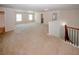 Spacious upstairs bonus room with plush carpeting and ample natural light at 2405 Brisbane Dr, Conyers, GA 30013