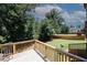 Outdoor deck overlooking a large, fenced backyard with mature trees at 2405 Brisbane Dr, Conyers, GA 30013