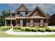 Charming brick two-story home with well-maintained landscaping and a welcoming front porch at 2405 Brisbane Dr, Conyers, GA 30013