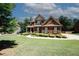 Charming brick home featuring a well-manicured lawn and established landscaping at 2405 Brisbane Dr, Conyers, GA 30013