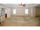 Spacious main bedroom with plush carpeting, neutral tones, and tray ceilings at 2405 Brisbane Dr, Conyers, GA 30013