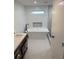 Bright bathroom with soaking tub, marble countertop, dark fixtures and recessed niche at 388 Sargent Se Dr, Atlanta, GA 30315