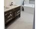Bathroom featuring a dual sink vanity with marble countertops and dark wood cabinets at 388 Sargent Se Dr, Atlanta, GA 30315
