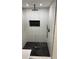 Shower featuring rainfall shower head, black and white marble tile, and recessed niche at 388 Sargent Se Dr, Atlanta, GA 30315