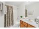 Bright bathroom with a shower-tub combo, a wood vanity and clean white finishes at 441 Mountain View Ln, Woodstock, GA 30188