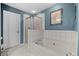 Modern bathroom with soaking tub, glass enclosed shower and white tile at 441 Mountain View Ln, Woodstock, GA 30188