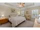 Comfortable bedroom with tray ceiling, a ceiling fan, and carpet floors at 441 Mountain View Ln, Woodstock, GA 30188
