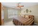 Bedroom featuring tan walls, carpet floor, ceiling fan and window with blinds at 441 Mountain View Ln, Woodstock, GA 30188