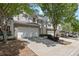 A view of the townhome complex with private driveways and mature trees at 441 Mountain View Ln, Woodstock, GA 30188