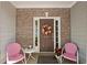 Charming front porch with chairs and floral decorations creating a welcoming space at 441 Mountain View Ln, Woodstock, GA 30188