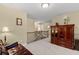 Carpeted hallway with staircase, dark metal railings, and view of a sitting area at 441 Mountain View Ln, Woodstock, GA 30188