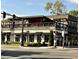 Exterior shot of a stylish two-story restaurant with outdoor seating and modern design at 441 Mountain View Ln, Woodstock, GA 30188