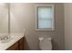 Bathroom features a vanity, a window and a toilet at 1045 Summer Hill Nw Ct, Acworth, GA 30102