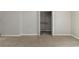 Cozy bedroom featuring neutral walls, soft carpet, and a walk-in closet for ample storage at 1045 Summer Hill Nw Ct, Acworth, GA 30102