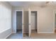 Sunlit bedroom offers dual walk-in closets, a window, and soft carpet at 1045 Summer Hill Nw Ct, Acworth, GA 30102