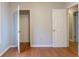 An airy bedroom with hardwood floors, closet and bright white doors at 1045 Summer Hill Nw Ct, Acworth, GA 30102