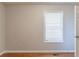 A light filled bedroom featuring a large window and classic hardwood floors at 1045 Summer Hill Nw Ct, Acworth, GA 30102