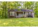 Charming single-story home with a well-manicured front yard and beautiful landscaping at 1045 Summer Hill Nw Ct, Acworth, GA 30102
