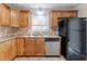 Well-equipped kitchen with granite countertops, stainless steel appliances, and tile backsplash at 1045 Summer Hill Nw Ct, Acworth, GA 30102