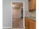 View of kitchen from dining room with countertops and light-colored cabinetry at 1045 Summer Hill Nw Ct, Acworth, GA 30102