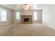 Spacious living room featuring a cozy stone fireplace and lots of natural light at 1045 Summer Hill Nw Ct, Acworth, GA 30102
