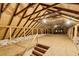 Unfinished attic with plywood flooring, exposed beams, and insulation at 120 Warren Ne St, Atlanta, GA 30317