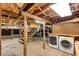 Unfinished basement with exposed wood beams, laundry area, and stairs at 120 Warren Ne St, Atlanta, GA 30317