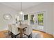 Bright dining room with a wooden table, white chairs, and access to an outdoor space at 120 Warren Ne St, Atlanta, GA 30317