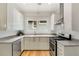Modern kitchen with white cabinets, granite countertops, and stainless steel appliances at 120 Warren Ne St, Atlanta, GA 30317