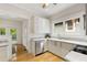 Bright kitchen with sleek white cabinets, stainless steel appliances, and hardwood flooring at 120 Warren Ne St, Atlanta, GA 30317