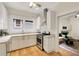 Well-lit kitchen with white cabinets, stainless steel appliances, and a view into the living room at 120 Warren Ne St, Atlanta, GA 30317