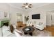 Inviting living room featuring a decorative fireplace, ceiling fan, and stylish seating arrangement at 120 Warren Ne St, Atlanta, GA 30317
