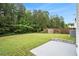 Expansive backyard featuring mature trees, lawn, and a small concrete patio at 2722 South Hills, Riverdale, GA 30296