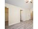 This bedroom has neutral walls, wood-look floors, an open closet, and bright, natural light at 2722 South Hills, Riverdale, GA 30296