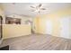 Open-concept living room with wood-look floors and bright yellow walls at 2722 South Hills, Riverdale, GA 30296